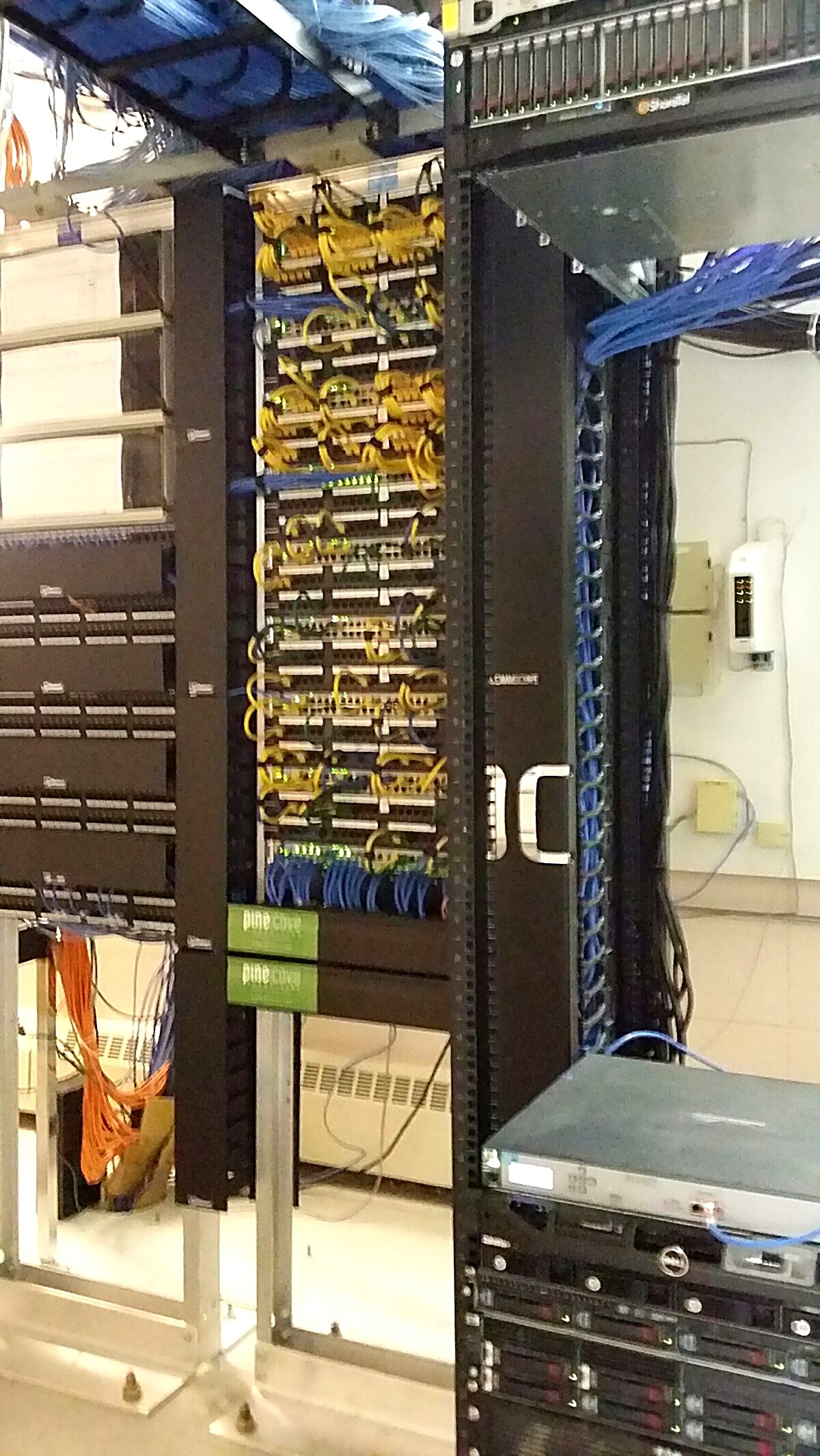 Cleanly organized, labeled network cabling in a server rack after Pine Cove work